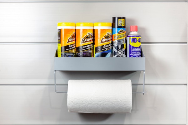 Paper Towel Rack. TOWELRK-V2. The perfect all-in-one supply station. The practical shelf accommodates a range of cleaning products, motor oil jugs and sprays. Mount a paper towel roll, ribbon rolls, shop towels or various tapes on the dowel below.